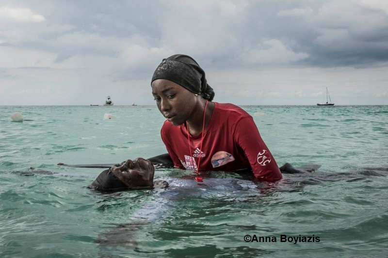 color photograph of swim instructor teaching young woman to float